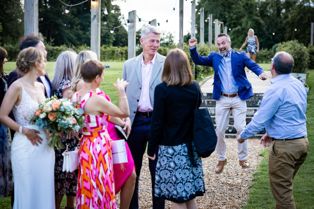 Wedding guest jumping in the air.