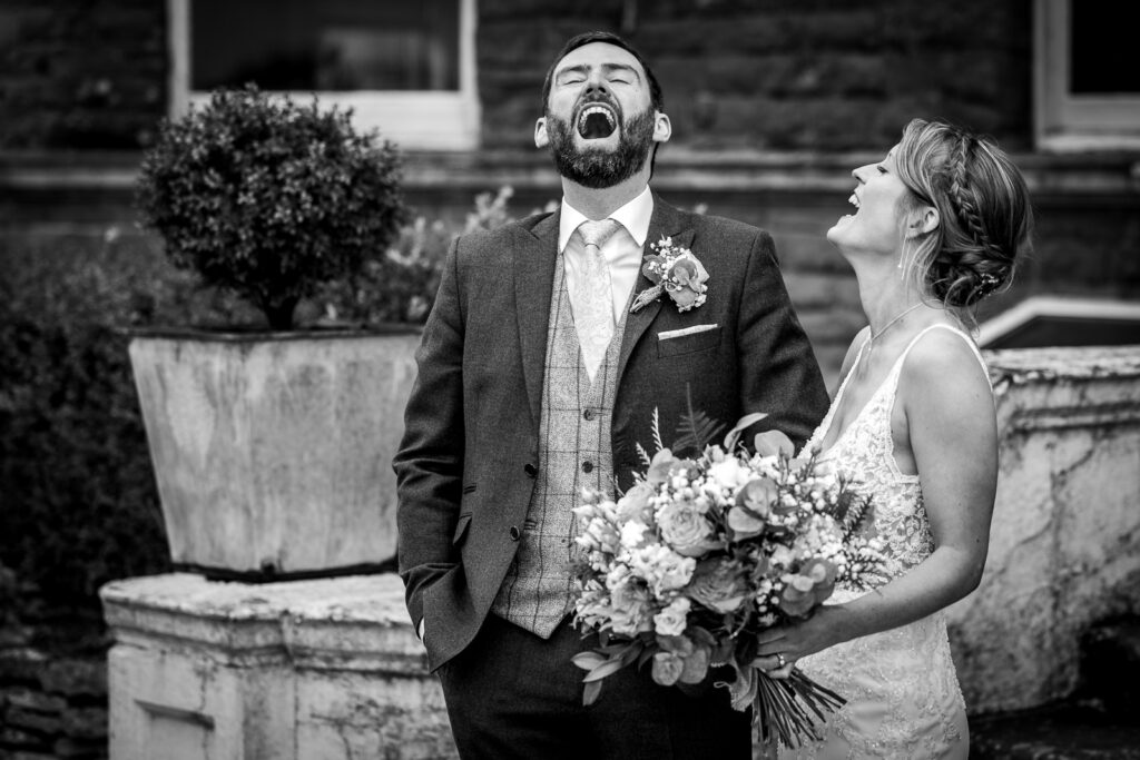 Bride and groom laughing.