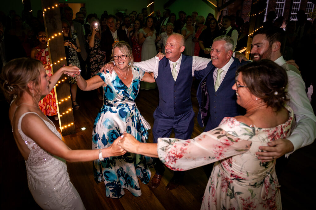 Bride and groom dancing with family at Bredenbury Court.