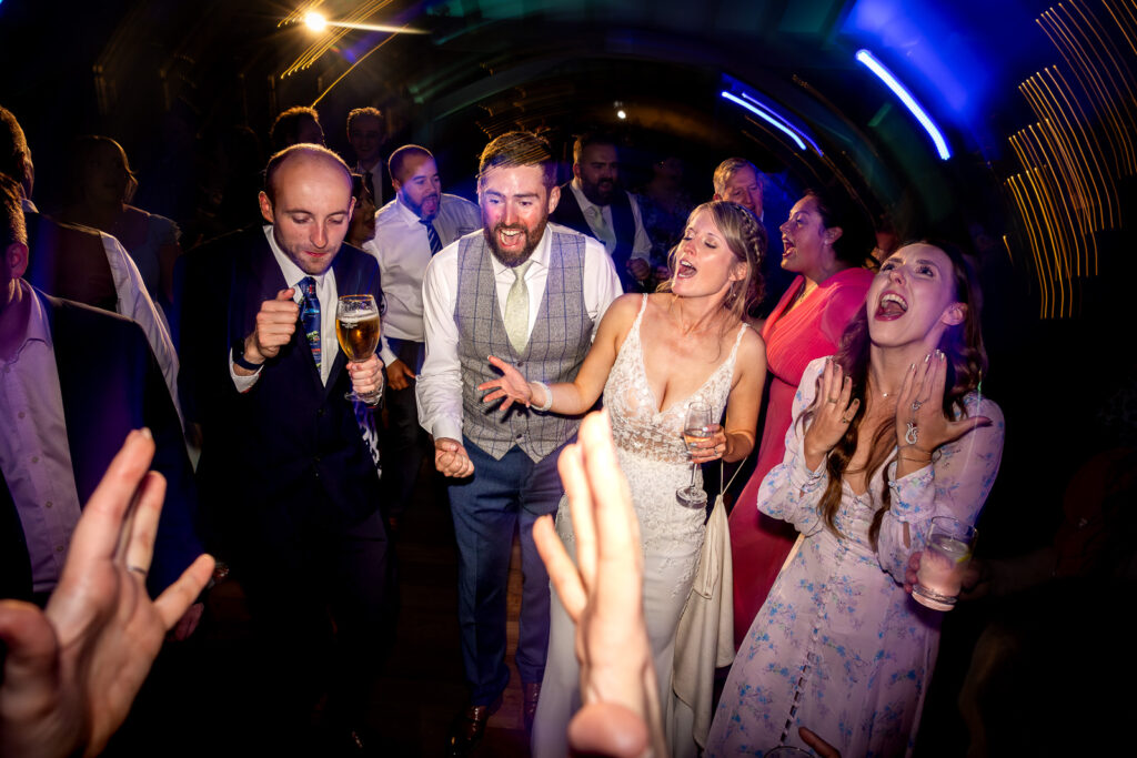 Bride and groom dancing with wedding guests.