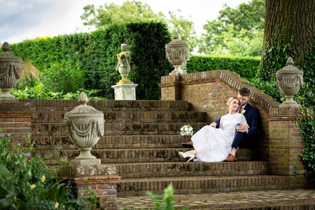 Bride and groom sitting on steps.