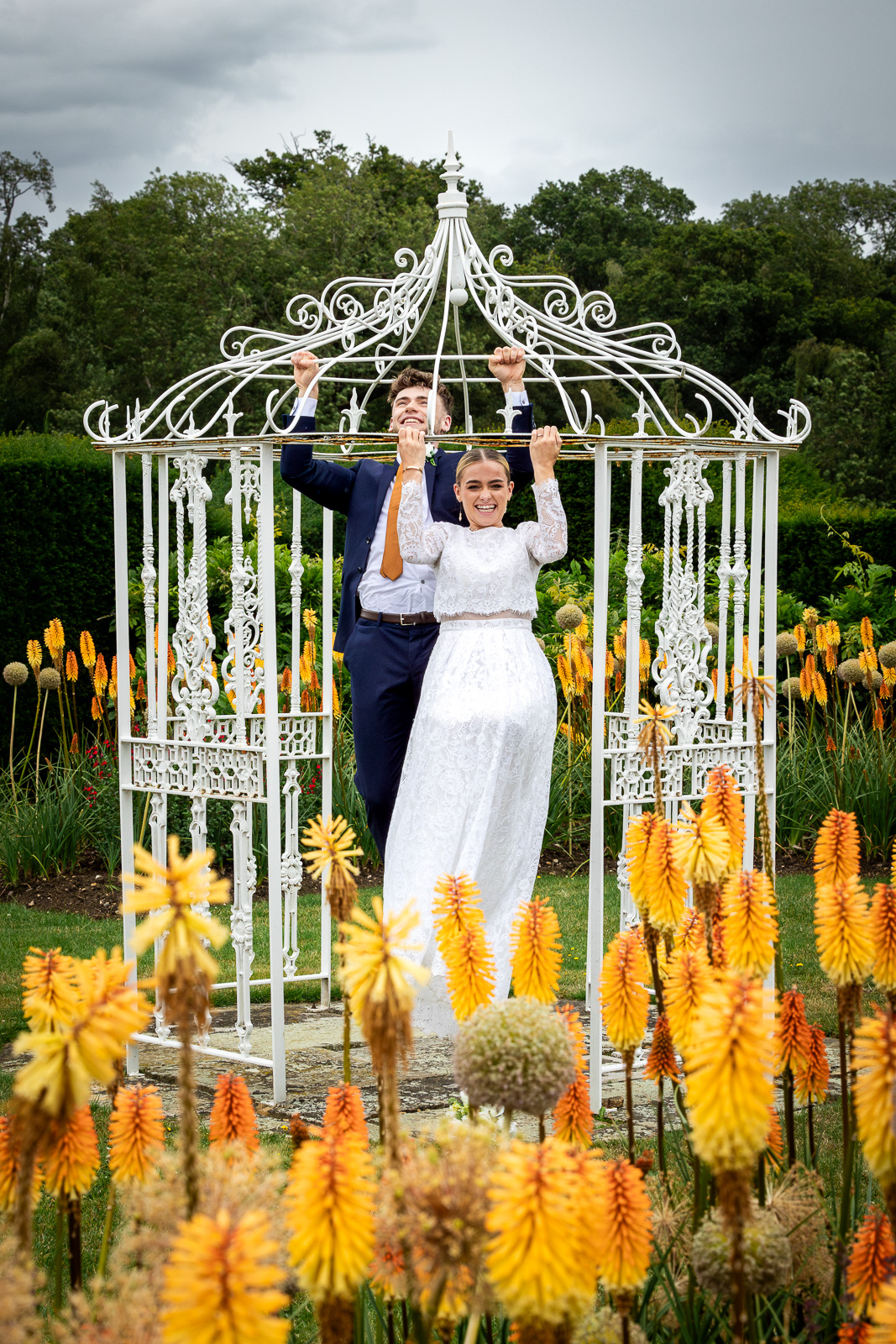 Bride and groom doing pull-ups.