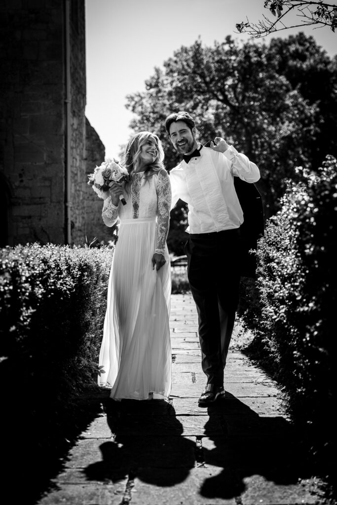 Bride and groom walking down a path.