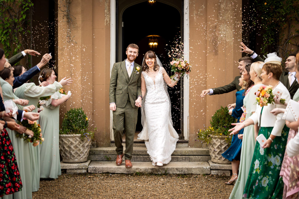 A couple starting their confetti line at Nurstead Court.