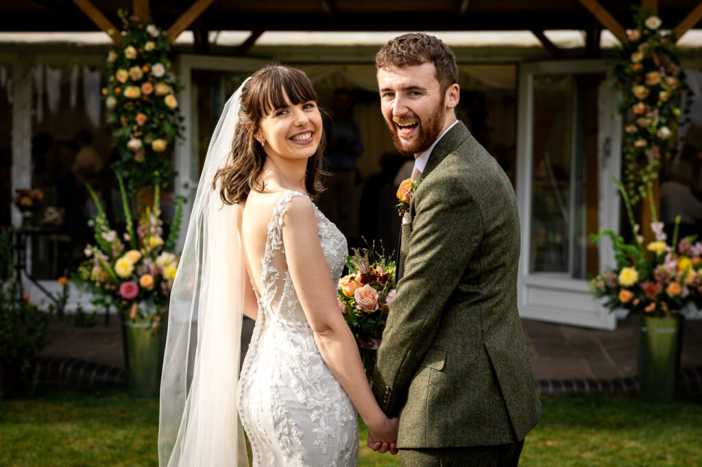 A bride and groom going into their wedding breakfast.