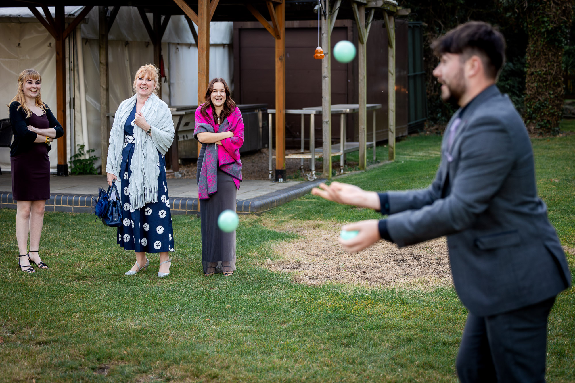 A wedding guest juggling.