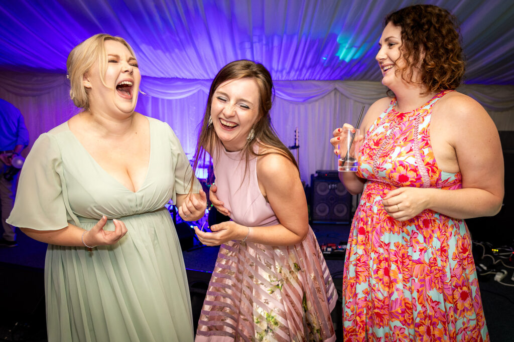 Girls laughing on the dance floor.